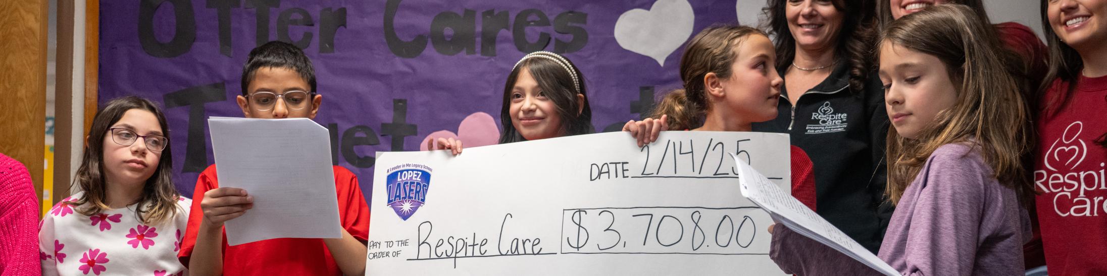 Students holding giant check